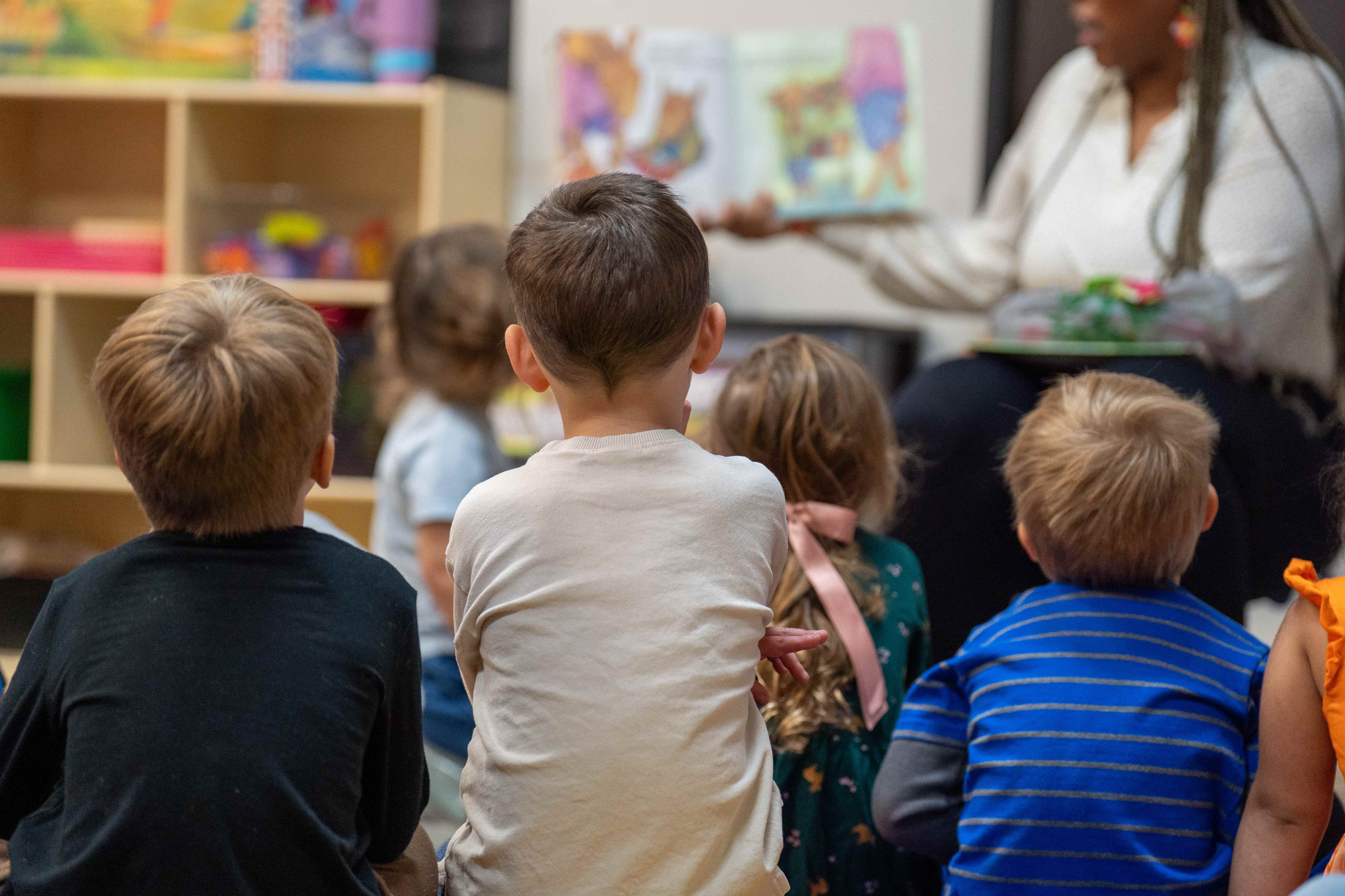 Teacher reading to children during story time