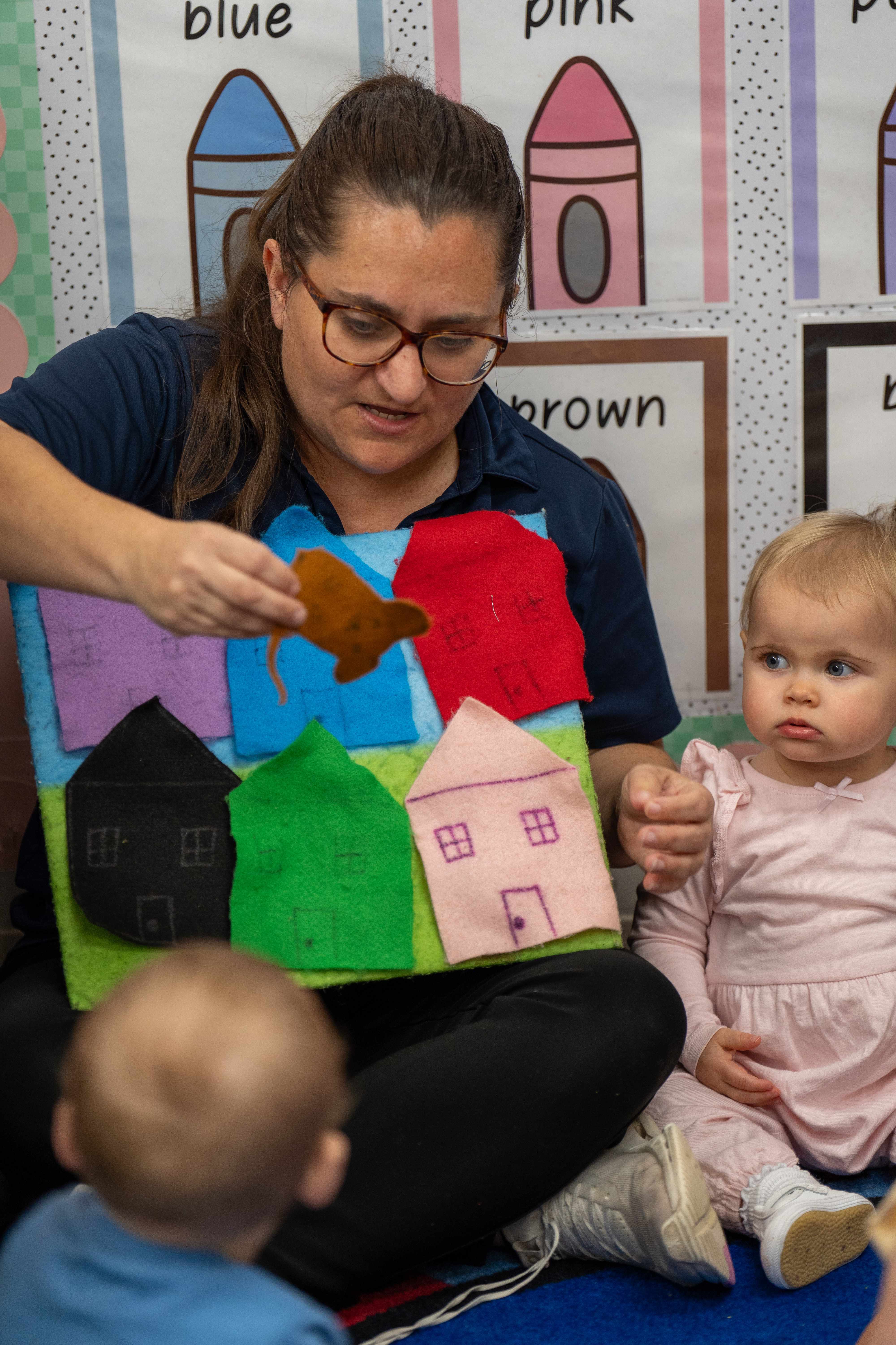 Teacher using felt board with toddlers