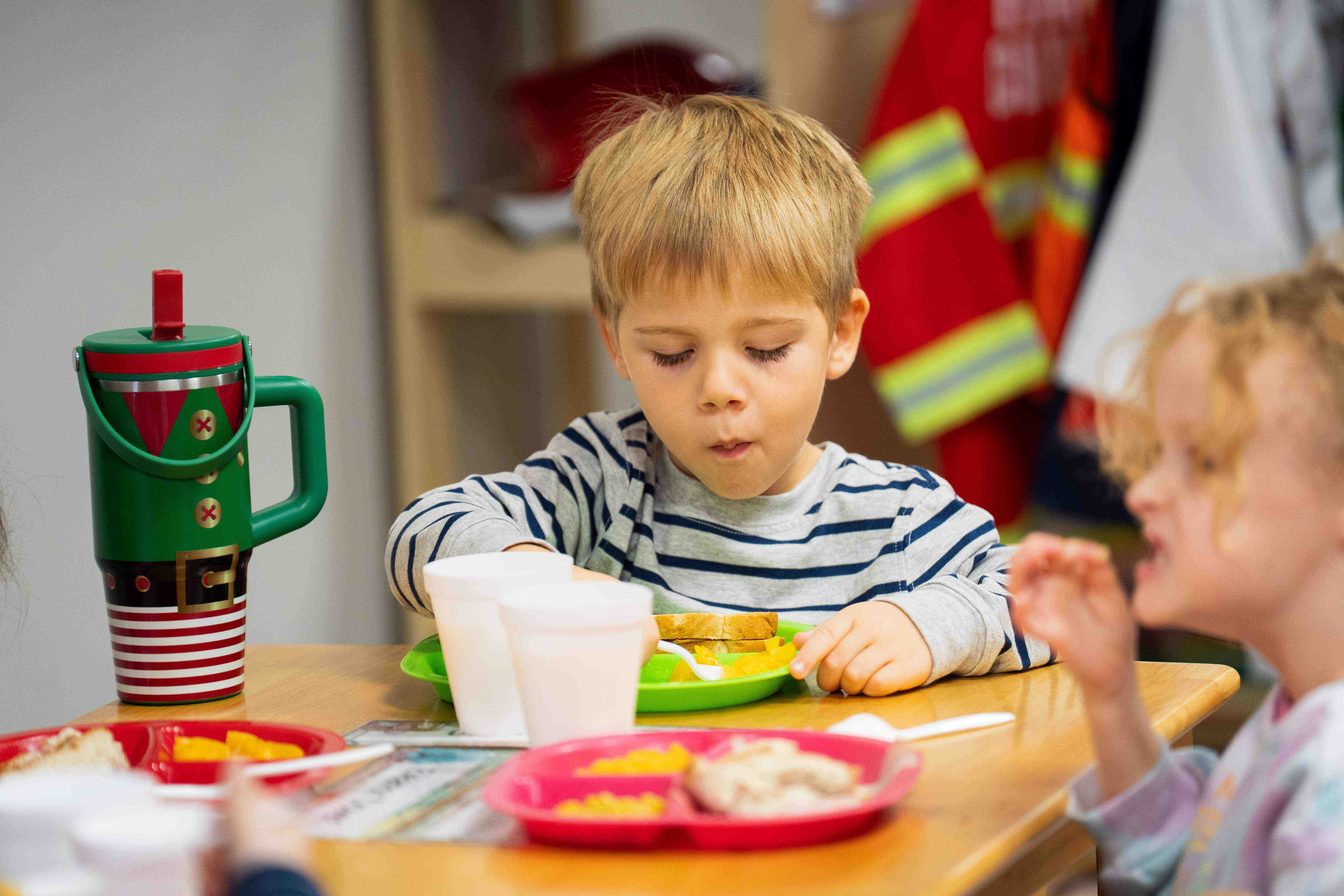 Child enjoying a nutritious meal at Gifted Early Learning Academy